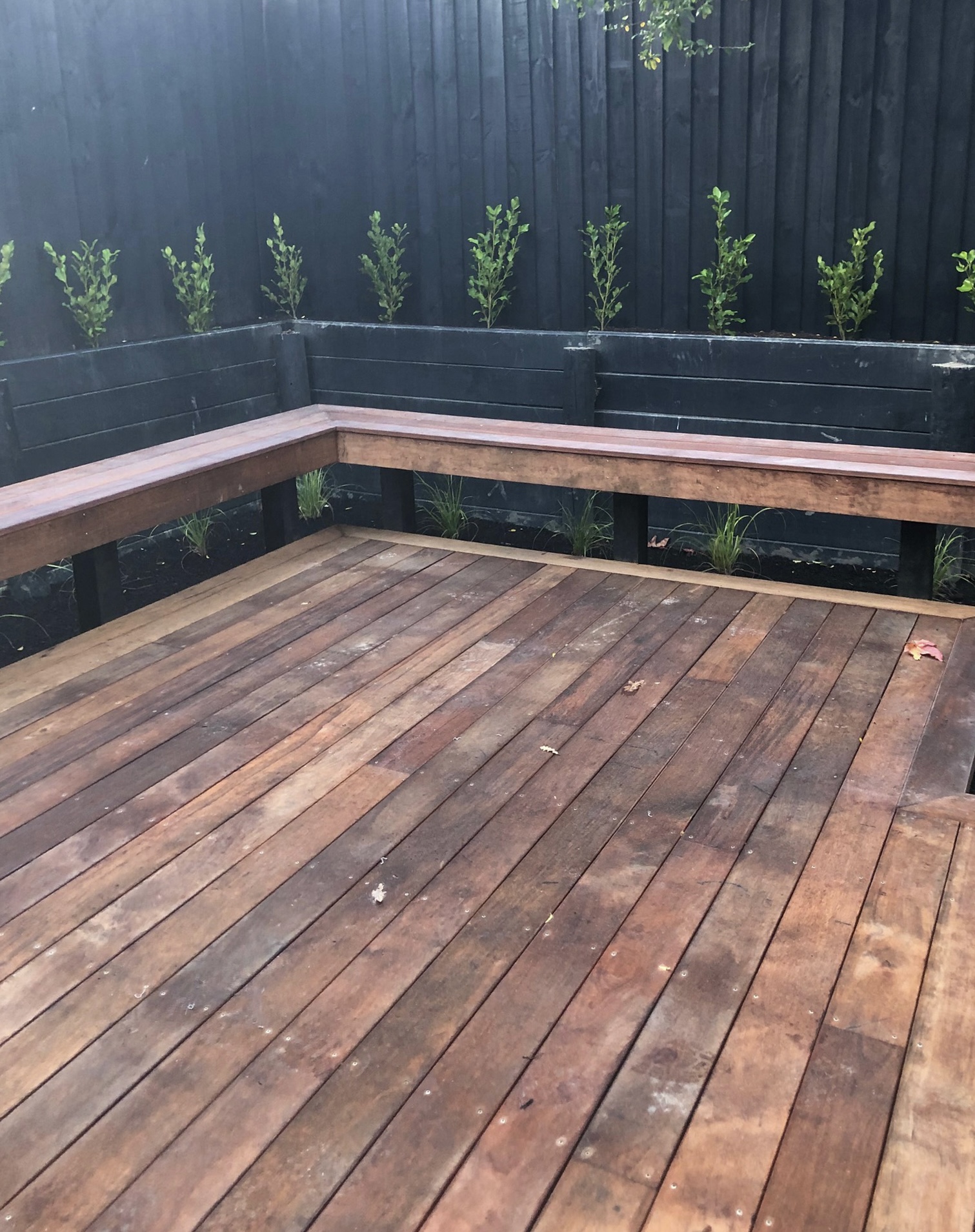 Hardwood deck with built-in bench seating and planter